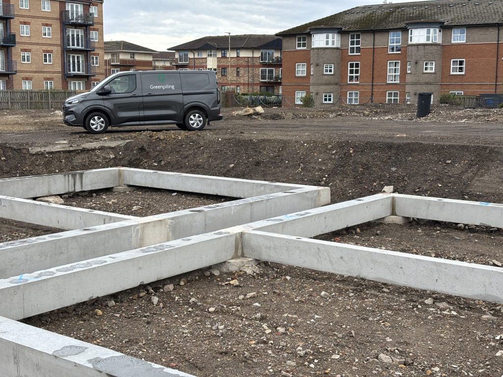 Close up shot of G-sPan precast ground beams with a Green Piling van in the background